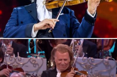 As the Lights Dimmed and a Hush Fell Over the Room, the First Ethereal Notes of “The Music of the Night” Unfolded Like Velvet in the Darkness. Then—Bathed in a Single, Golden Spotlight—Jackie Evancho Stepped Forward, Her Voice Delicate Yet Hauntingly Powerful, Rising Like a Whispered Secret in the Stillnesswith a Single Sweep of the Bow, Time Bends—Past and Present Melt Into One Seamless, Silken Thread as the Second Waltz Unfurls in All Its Haunting Majesty. At the Heart of It Stands André Rieu, Masterful and Magnetic, Conducting With a Precision Laced in Deep Emotion. Each Note Pulses With Nostalgia and Reverie, Guiding the Orchestra Like a Tide of Memory, While the Audience Leans In, Breathless, as if Afraid To Break the Enchantment. The Performance Is Not Merely Heard—It’s Felt, Lived. In That Ballroom of Sound, Where Elegance Meets Soul, Rieu Creates a Moment So Beautiful, so Achingly Timeless, That It Feels Like the World Has Stopped—Just Long Enough To Dance.