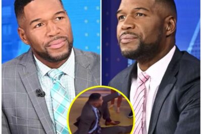 Viewers were left stunned and terrified this morning after Good Morning America host Michael Strahan suddenly collapsed mid-broadcast, forcing an abrupt cut to commercial and leaving fans across the country asking the same question: “What happened to Michael?” Moments before the incident, Strahan had been laughing with co-host Robin Roberts, when witnesses say his expression changed — “he went pale, grabbed the desk, and just fell.” Producers rushed to his aid as Robin could be heard off-camera saying, “Michael, are you OK? Somebody get help!” The studio fell silent. When the show returned, George Stephanopoulos assured viewers that Michael was receiving medical attention — but offered no further details.