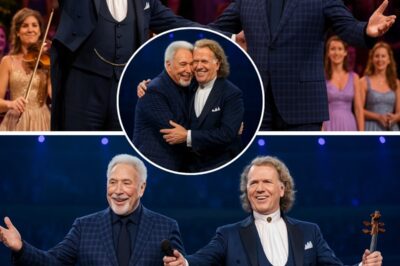 “When Two Legends Embrace—Tom Jones and André Rieu Turn a Summer Night into Forever”. The soft golden lights bathed the open-air stage in Maastricht like a dream suspended in time, while thousands held their breath beneath the starlit sky. Then, as if summoned by memory and magic, Sir Tom Jones emerged—his voice rich with soul, blending seamlessly with the tender cry of André Rieu’s violin. They stood side by side, two titans from different worlds, yet united in one heartbeat of music. “It’s not unusual,” Tom said with a grin, “but tonight feels like the first time.” And André, eyes shining, whispered, “Because this moment belongs to love.” It wasn’t just a duet—it was a miracle wrapped in melody.