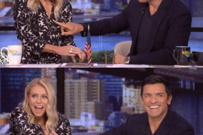 Mark Consuelos reaches over to rub wife’s torso after mic falls ‘deep into the cleavage’. See what they do next.