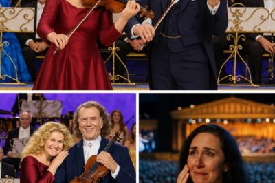 “I’ve seen him perform for thousands, but tonight… he played for his daughter — and for me.” A hush fell over the concert hall as André Rieu stepped into the soft spotlight, his beloved violin in hand. But this time, he wasn’t alone. Standing beside him was his daughter, Marisha — elegant, poised, and glowing with quiet pride. The moment their duet began, the air changed. Marisha’s voice, trembling with both strength and sentiment, wove effortlessly through the tender strains of her father’s violin. From the front row, Marjorie — wife, mother, silent pillar of their musical journey — sat with her hand to her heart, tears welling in her eyes. It wasn’t just music; it was memory, family, and love translated into sound. The audience, nearly 12,000 strong, watched in breathless awe as three hearts performed as one. In that moment, the stage didn’t belong to legends — it belonged to a family who dared to feel deeply, and share it with the world.