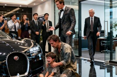 A Struggling Single Dad Walked Into a Luxury Car Dealership Just to Let His Son Sit in His Dream Car for a Moment — but a wealthy customer laughed loudly and told them to “leave before you dirty the leather.” The entire showroom froze. Then a senior executive stepped out of his office, overheard everything, and said something that flipped the whole situation upside down… leaving the arrogant customer humiliated.